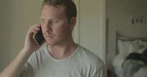 Man talks on smartphone at home Stock Footage 78038104