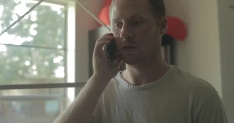 Man talks on smartphone at home Stock Footage 78038140