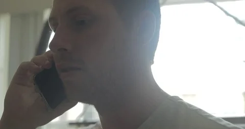 Man talks on smartphone at home Stock Footage 78038144