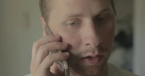 Man talks on smartphone at home Stock Footage 78038149