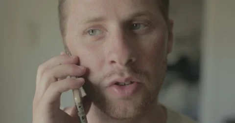 Man talks on smartphone at home Stock Footage 78038157
