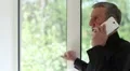 Man talks on a smartphone with a serious look of face HD Footage