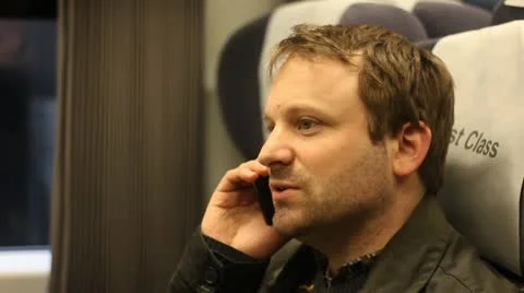 Man talks on train on cell phone Stock Footage 20632663