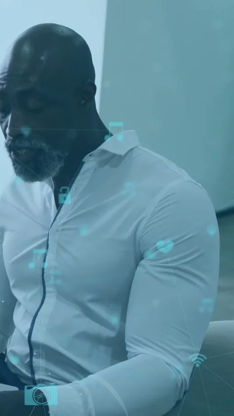 Man tapping device in office animating tech icons lock hiding hands then Stock Footage 333069610