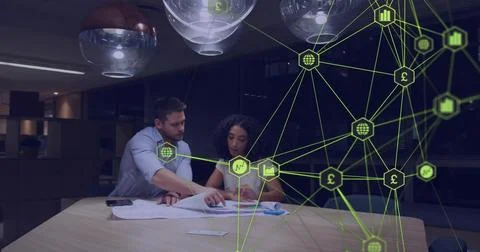 Man tapping docs and pointing, woman writing, team reviewing finance, green net Stock Photos