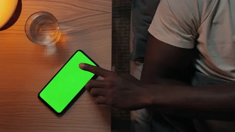 Man tapping on green screen of mobile for turning off lights Video stock 164969671