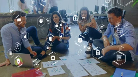 Man tapping laptop causing team on floor sorting charts while AR hex icons Stock Footage 334788691