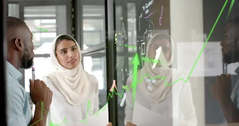 Man tapping marker on glass panel drawing arrow while woman marking data fueling Stockbeeldmateriaal 314397715