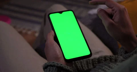 Man tapping on mobile phone green screen at home Stock Footage 147362149