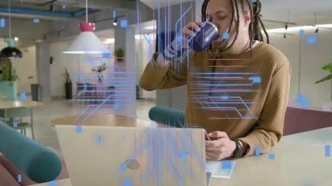 Man tapping phone and causing tech overlays above laptop, pulsing then settling Stock Footage 333369049