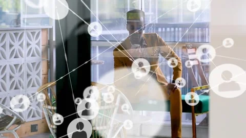 Man tapping phone and reviewing animated user icons growing across glass Stock Footage 334115754