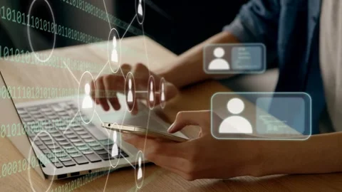 Man tapping phone and typing on laptop at wooden desk, animating technology Stock Footage 334351881