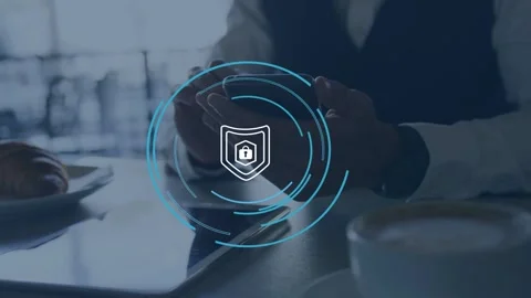 Man tapping phone at cafe table, initiating pulsing shield and rings around Stock Footage 334884193