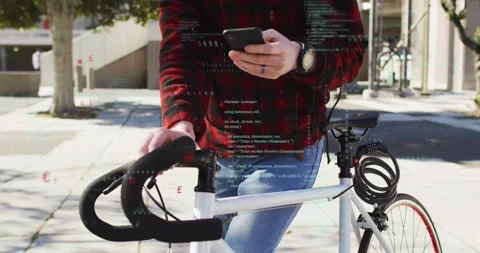 Man tapping phone, leaning on bicycle with cable lock, activating tech overlays Stock Footage 321099978