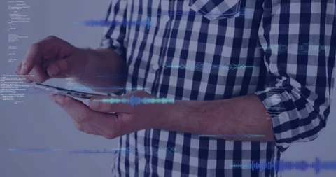 Man tapping phone in light-gray studio, causing blue holo waveforms and code Stock Footage 328584483