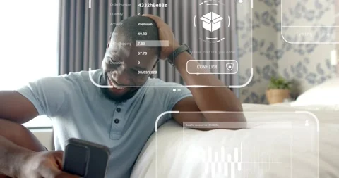 Man tapping phone while scrolling on bed, causing calendar, graphs, map Stock Footage 321715163