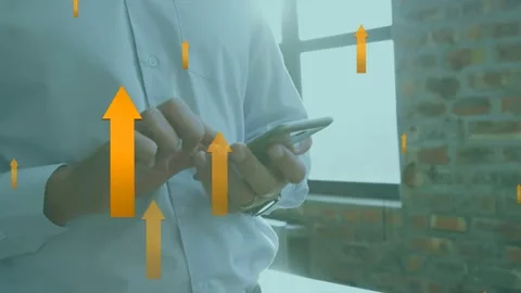 Man tapping phone by window generating orange arrows rising obscuring hands Stock Footage 334466028