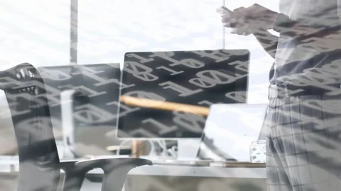 Man tapping smartphone and activating binary overlay over desk, monitors, chair Stock Footage 334788589
