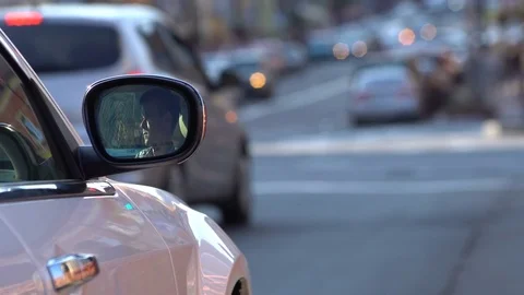 Man tapping smartphone behind the wheel in traffic Stock Footage 69807935