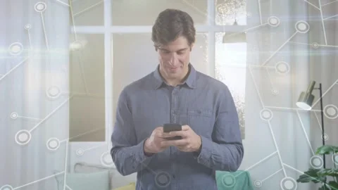 Man tapping smartphone, replying to message at home, causing tech network nodes Stock Footage 333552792