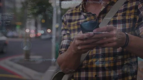 Man tapping smartphone on sidewalk at dusk, causing technology waveform-code Stock Footage 333318385