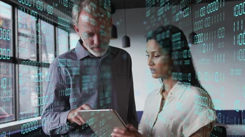 Man tapping tablet activating binary overlay for tech review while woman holding Stock Footage 333818085