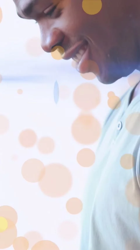 Man tapping tablet, activating bokeh UI, pulling back, smiling, showing tech for Stock Footage 334319248