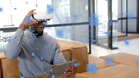 Man tapping tablet, activating holo UI in office, pulling VR headset for Stock Footage 334351670