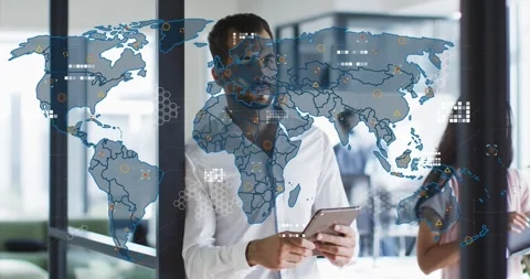 Man tapping tablet and projecting world map on glass while reviewing business Stock Footage 334312821