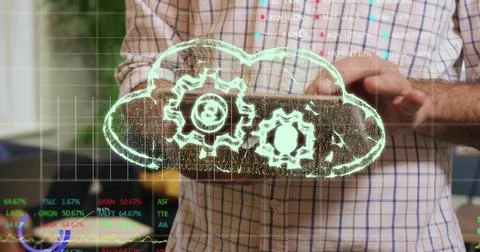 Man tapping tablet and spawning holographic cloud with gears above tablet, Stock Photos
