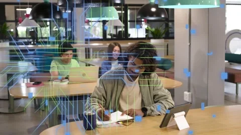 Man tapping tablet and writing study notes in tech space, causing code overlay Stock Footage 334728706