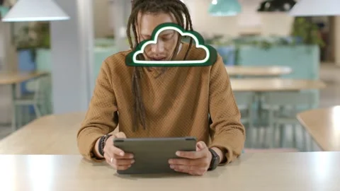 Man tapping tablet in cafeteria, animating green bars and white frames into Stock Footage 329959738