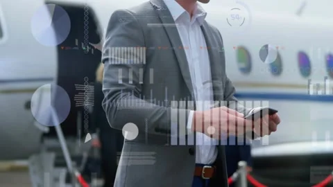 Man tapping tablet, causing flight data overlays across jet while colleagues Stock Footage 331593429