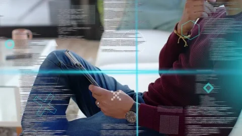Man tapping tablet causing teal HUD scrolling code overlaying, pulling back and Stock Footage 333221407