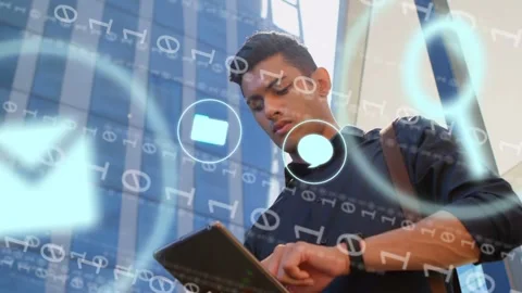 Man tapping tablet by glass office tower, navigating apps to sync data with Stock Footage 334743773