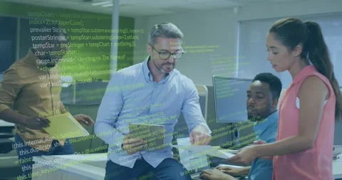 Man tapping tablet, initiating floating green code overlay while team reviewing Stock Footage 330208227