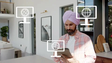 Man tapping tablet at island, causing monitor and envelope icons indicating tech Stock Footage 334014014