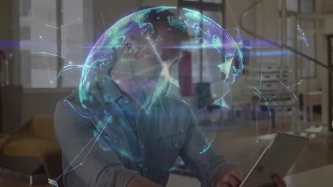 Man tapping tablet in loft, animating 3D globe over device, pulsing data points Stock Footage 331005823