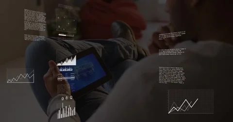 Man tapping tablet in lounge, causing pulsing data overlays, marking charts and Stockbeeldmateriaal 331109481
