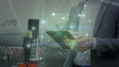 Man tapping tablet near jet, lighting network nodes and showing business data Video stock 332296510