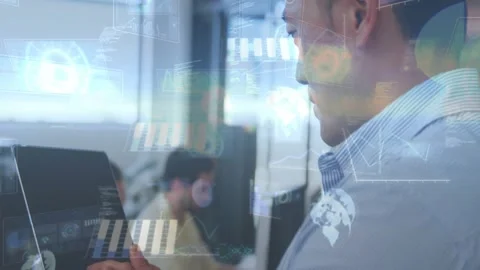 Man tapping tablet in office, activating HUD charts aligning with tablet and Stock Footage 333900223