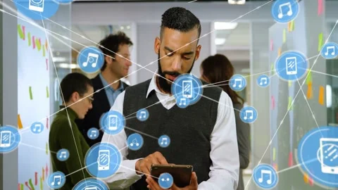 Man tapping tablet in office, causing blue icon net growing across sticky notes Stock Footage 332901702