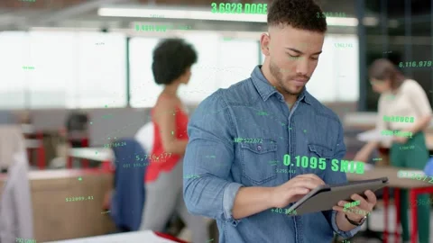 Man tapping tablet in open office, checking crypto data, overlays enlarging, Stock Footage 333061387