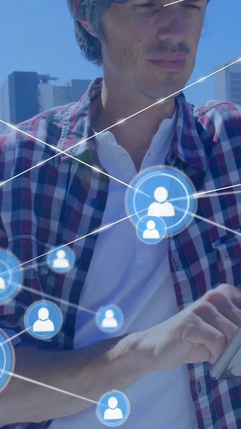 Man tapping tablet on rooftop causing blue user icons and lines forming tech Stock Footage 334396700