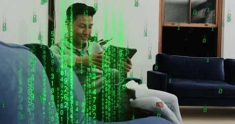 Man tapping tablet screen and generating digital code rain overlay in home Stock Footage 316133384