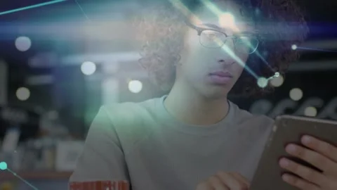 Man tapping tablet screen in cafe, technology network nodes pulsing around face Stock Footage 327849354