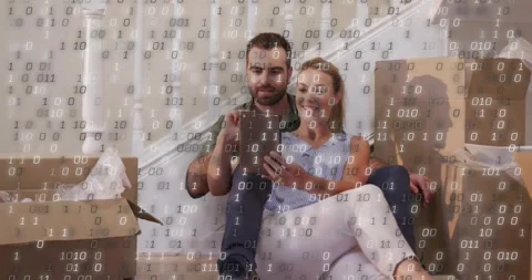 Man tapping tablet sparking falling binary overlay while couple leaning in, Vídeos de archivo 331712981