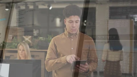 Man tapping tablet in technology office, with floating encryption code overlay Stock Footage 307433699