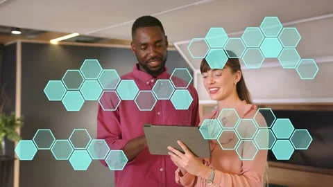 Man tapping tablet, woman scrolling, working in business lounge, teal hex Stockbeeldmateriaal 333351404