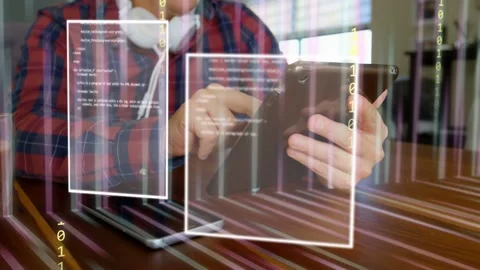 Man tapping tablet at wooden table, activating tech UI panels, binary streams, Stock Footage 334694066